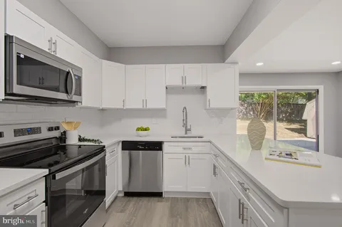 a kitchen with a sink stove and microwave