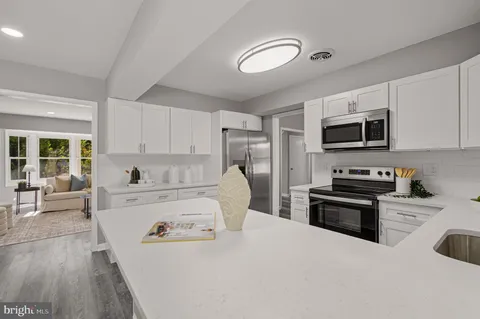 a kitchen with a refrigerator stove and microwave