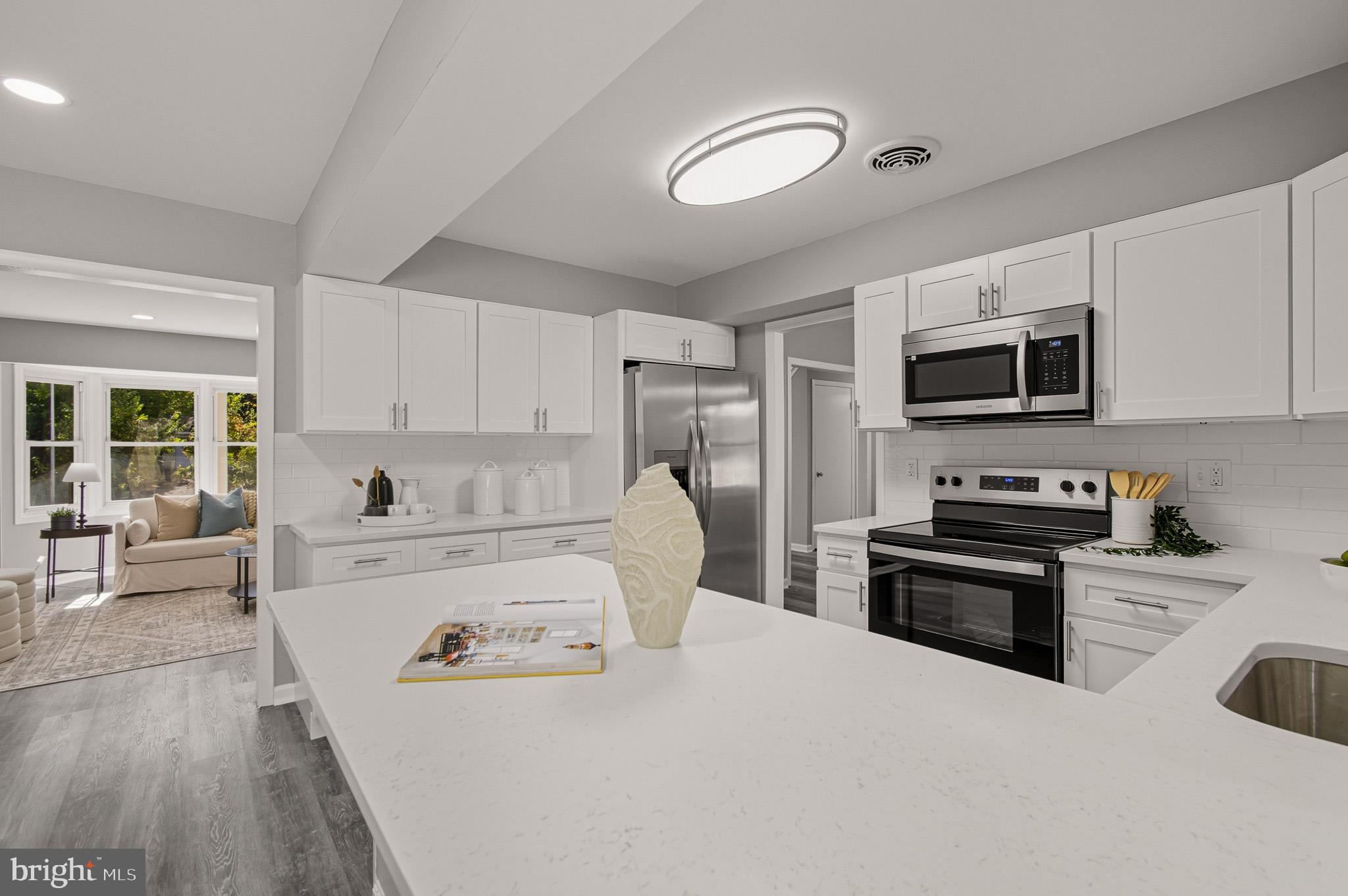 12414 Sandal Lane Bowie, MD 20715 - Photo 15 of 46 a kitchen with a refrigerator stove and microwave