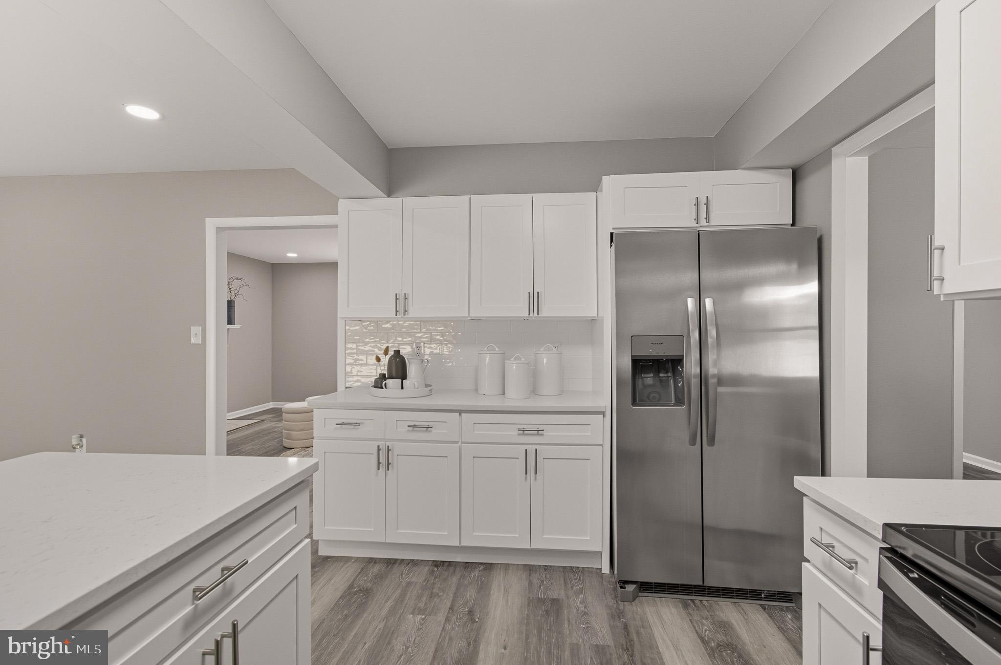 12414 Sandal Lane Bowie, MD 20715 - Photo 16 of 46 a kitchen with a sink cabinets stainless steel appliances and a window