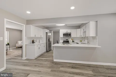 a view of kitchen with stainless steel appliances cabinets