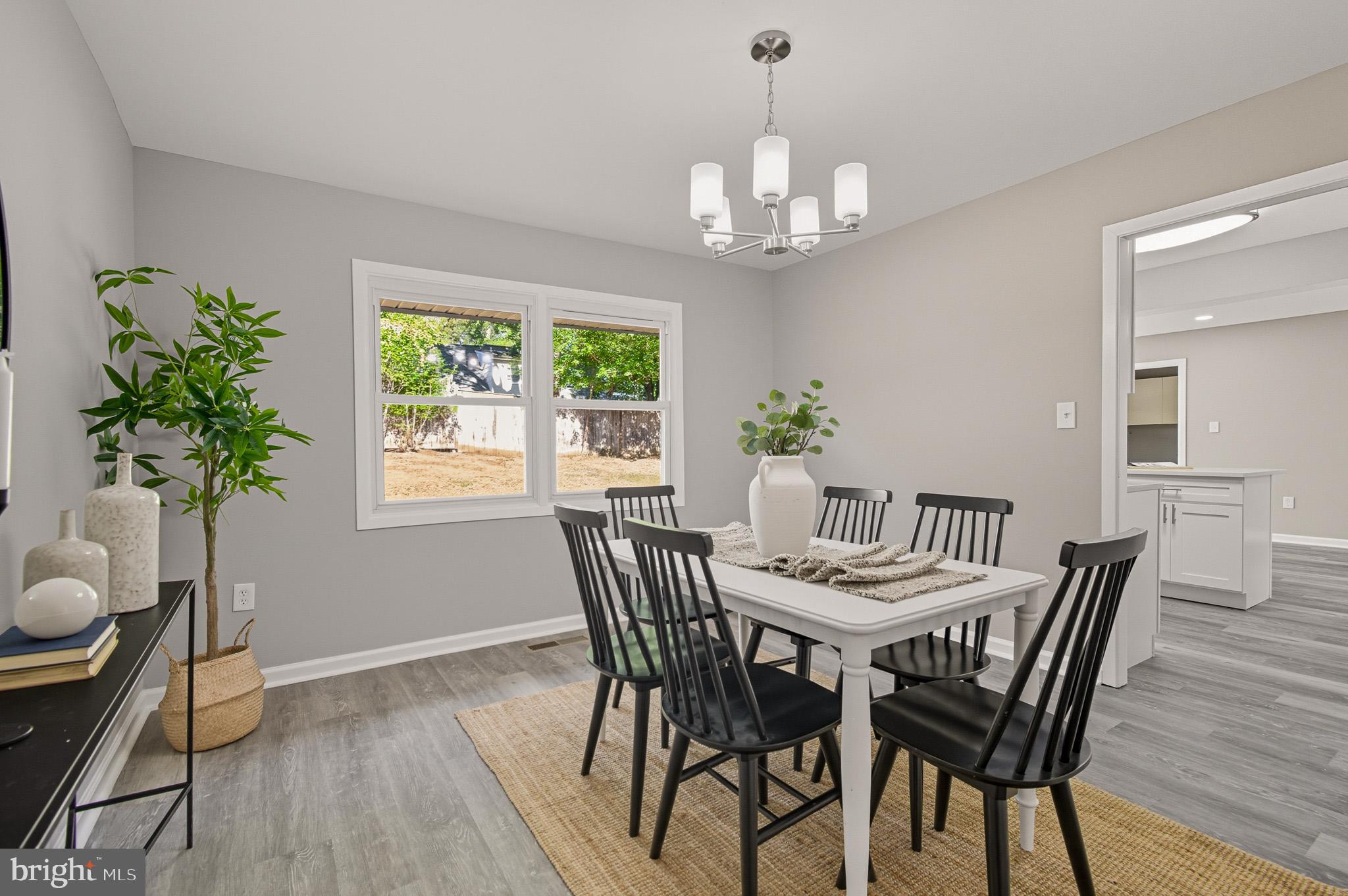 12414 Sandal Lane Bowie, MD 20715 - Photo 19 of 46 a view of a dining room with furniture window and wooden floor
