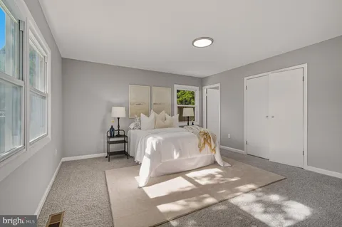 a spacious bedroom with a bed and window