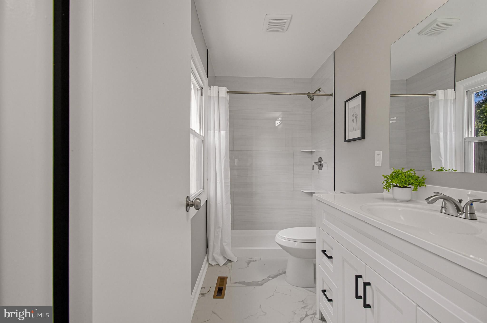 12414 Sandal Lane Bowie, MD 20715 - Photo 27 of 46 a bathroom with a sink a toilet and shower