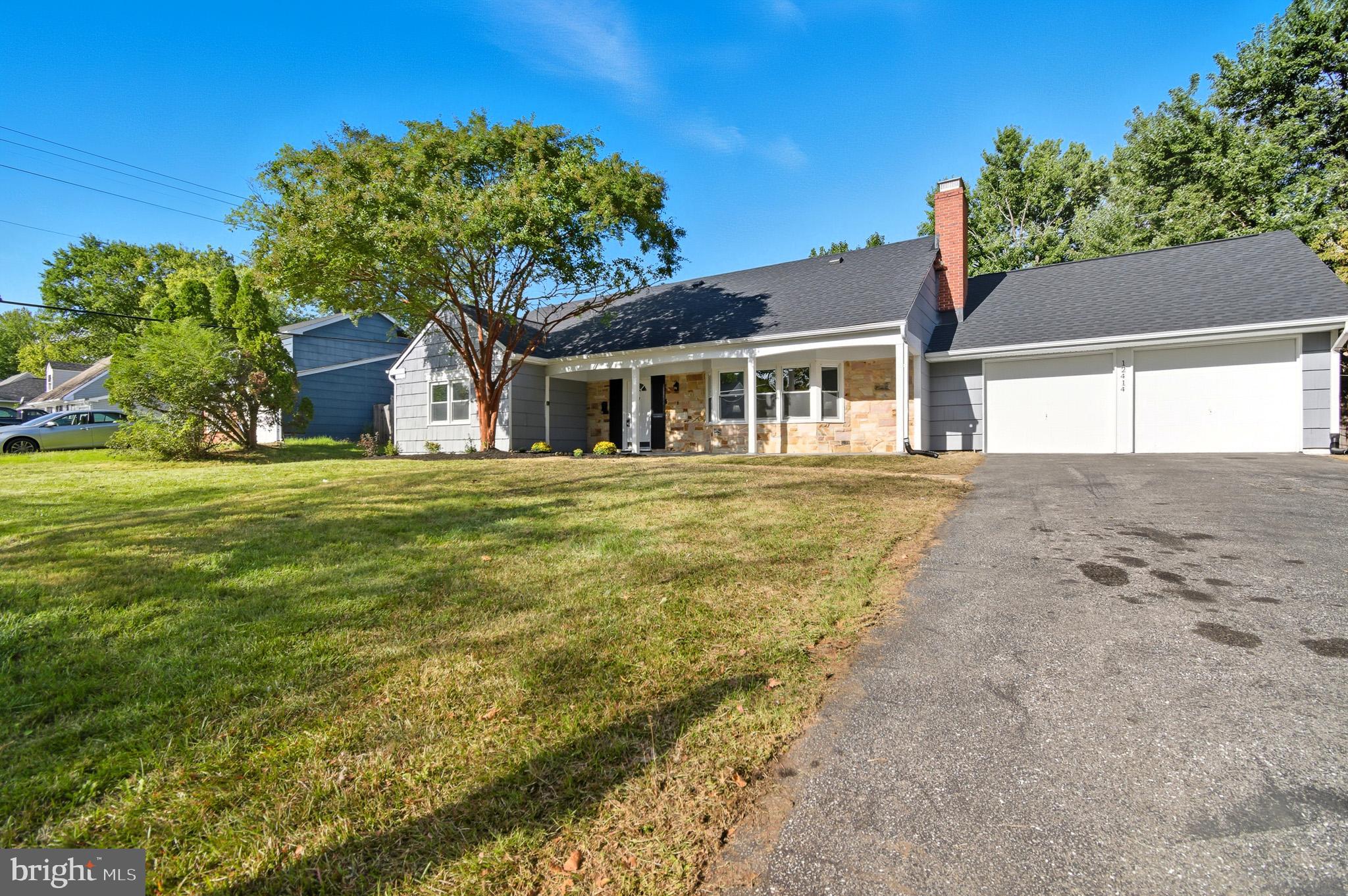 12414 Sandal Lane Bowie, MD 20715 - Photo 3 of 46 a front view of a house with a garden