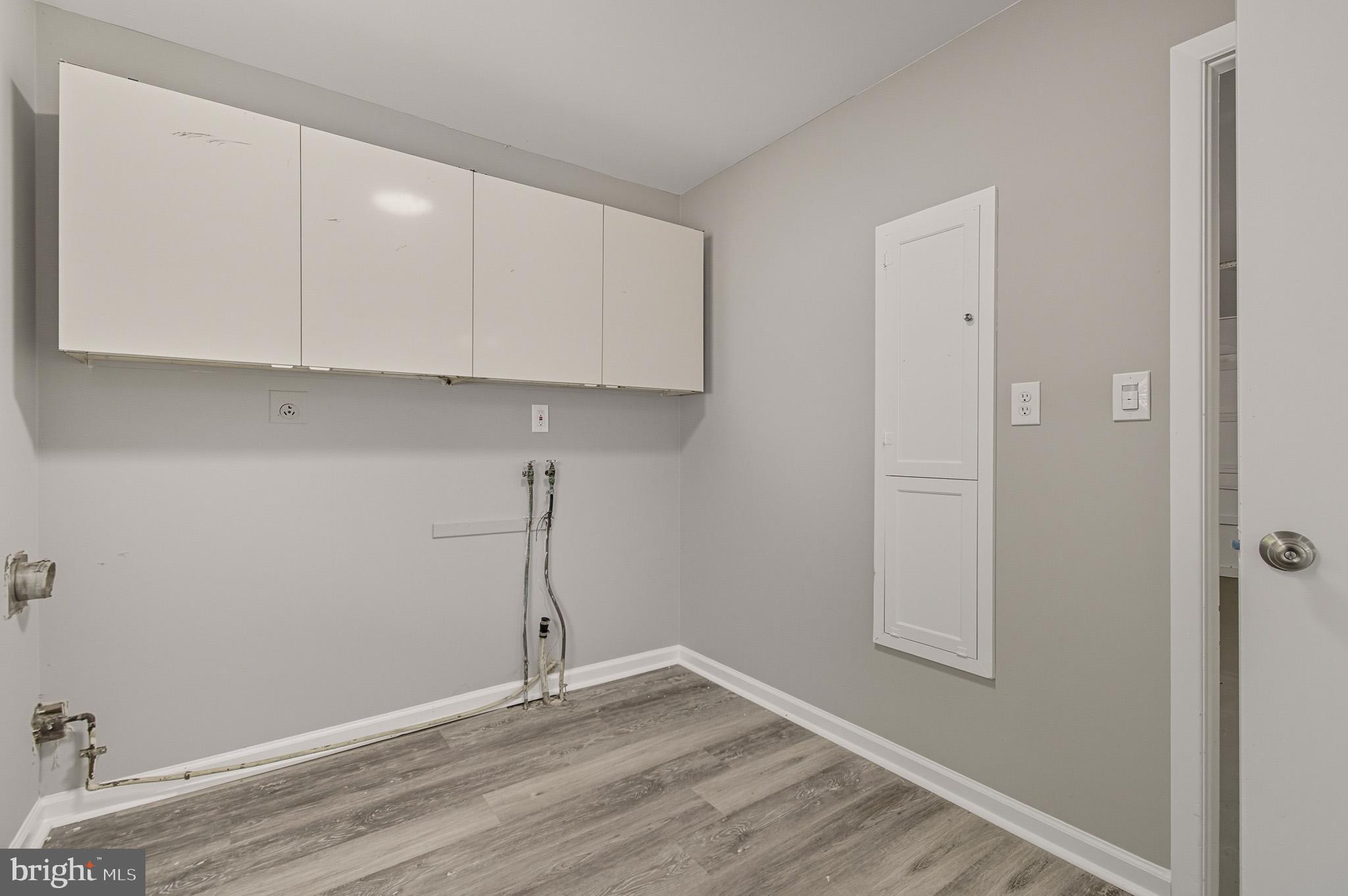 12414 Sandal Lane Bowie, MD 20715 - Photo 39 of 46 an empty room with wooden floor and cabinets