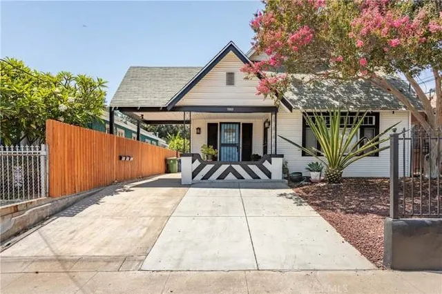 a view of a house with wooden fence