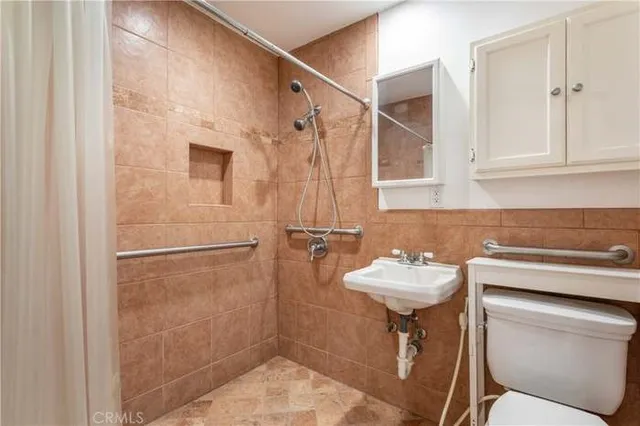 a bathroom with a sink toilet and shower