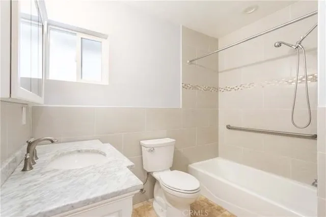 a white toilet sitting next to a bathroom sink