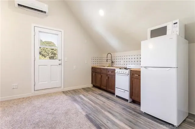 a view of a house with wooden fence