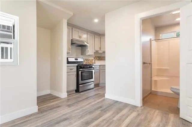 a kitchen with a sink a stove and a refrigerator