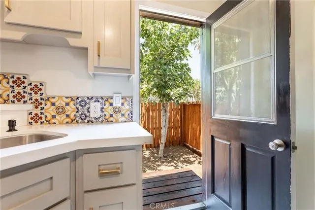 a view of a patio with table and chairs and potted plants