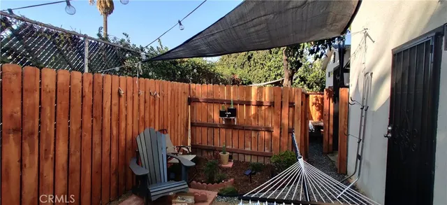 a view of a house with backyard and sitting area