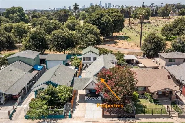 an aerial view of multiple houses with yard