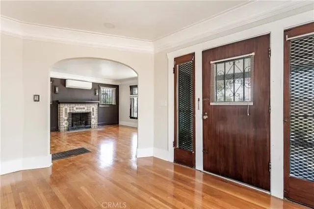 a view of a hallway with wooden floor and a fireplace