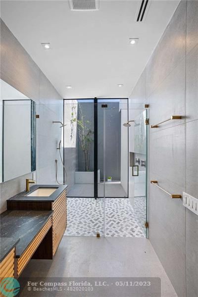 1904 Southwest 22nd Terrace Miami, FL 33145 - Photo 18 of 31 a large bathroom with a granite countertop sink a toilet a mirror and shower