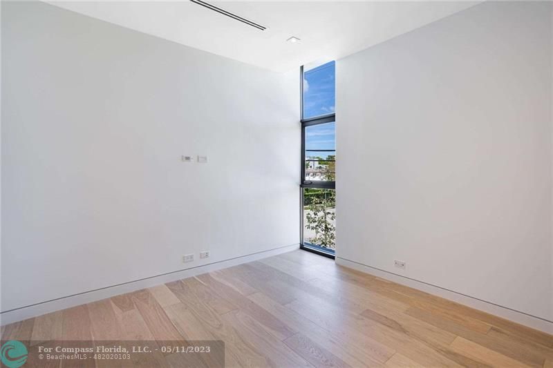 1904 Southwest 22nd Terrace Miami, FL 33145 - Photo 20 of 31 a view of an empty room with wooden floor and a window