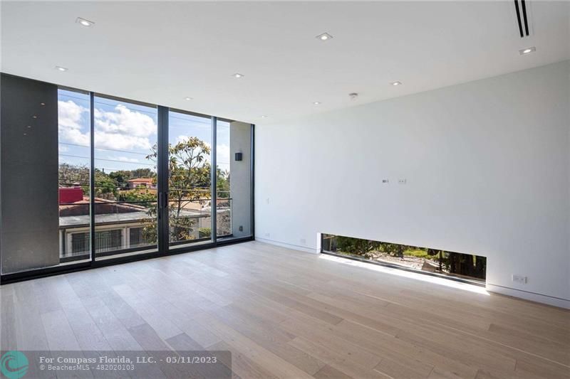 1904 Southwest 22nd Terrace Miami, FL 33145 - Photo 7 of 31 an empty room with wooden floor and glass door