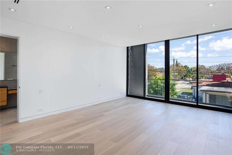 1904 Southwest 22nd Terrace Miami, FL 33145 - Photo 8 of 31 an empty room with wooden floor and windows