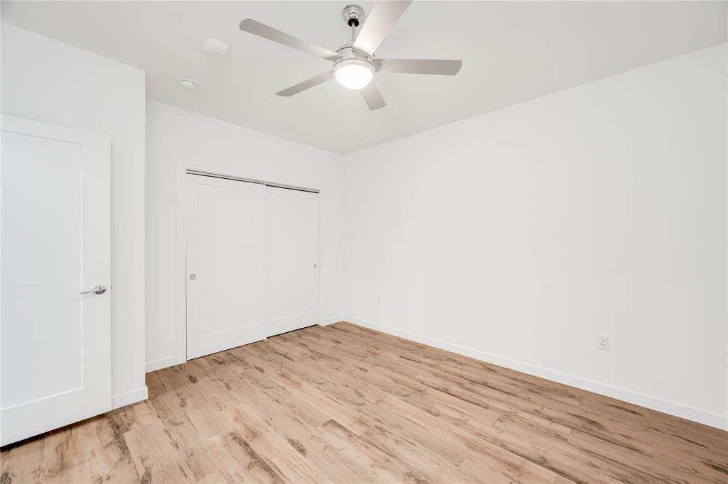4801 Springdale Road, Unit 1307 Austin, TX 78723 - Photo 13 of 30 a view of a big room with wooden floor and a ceiling fan