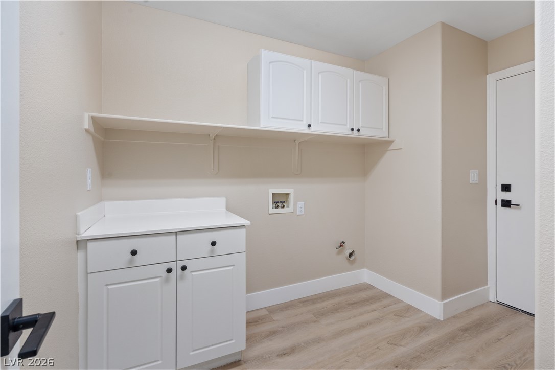 1662 Ravanusa Drive Henderson, NV 89052 - Photo 36 of 74 Functional utility space with ample storage and durable flooring awaits your laundry essentials.