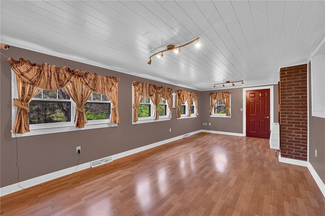 245 Cromer Road Williamston, SC 29697 - Photo 11 of 27 This inviting living space features gleaming wood flooring, track lighting, and abundant natural light.