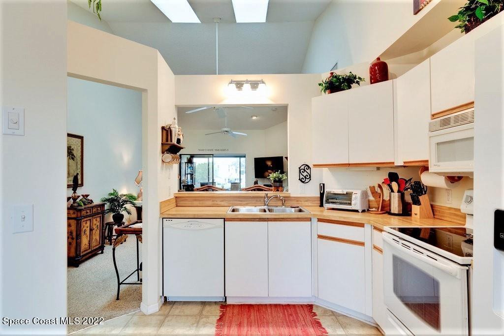 Undisclosed Address Sebastian, FL 32958 - Photo 21 of 33 a kitchen with a sink a stove and cabinets