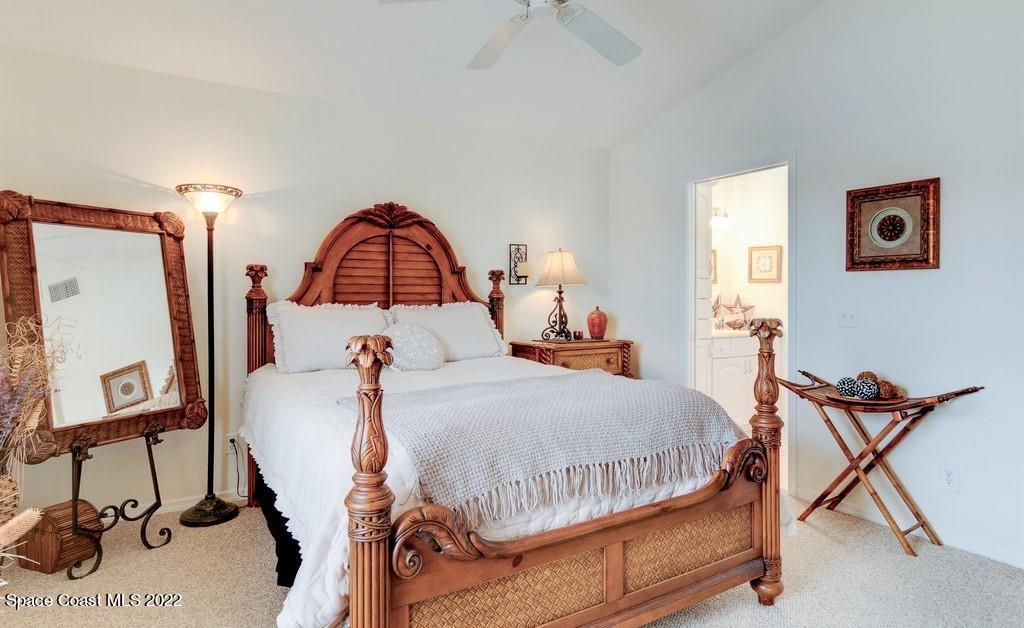 Undisclosed Address Sebastian, FL 32958 - Photo 24 of 33 a bedroom with a bed and dresser with mirror
