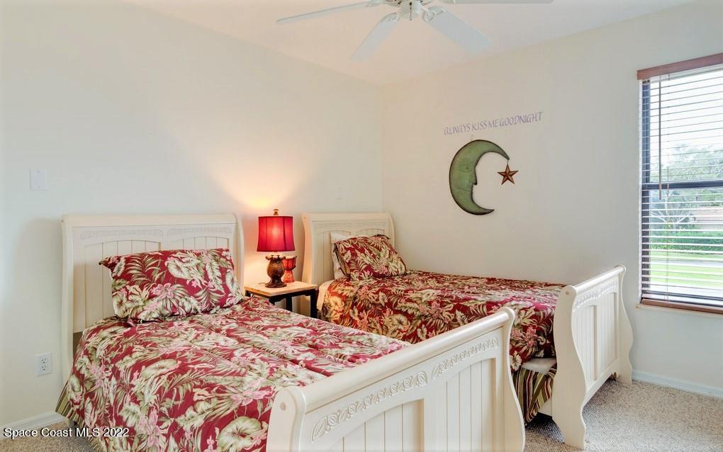 Undisclosed Address Sebastian, FL 32958 - Photo 27 of 33 a bedroom with two beds and a window
