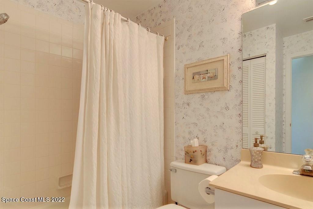 Undisclosed Address Sebastian, FL 32958 - Photo 29 of 33 a bathroom with a sink a toilet and shower curtain