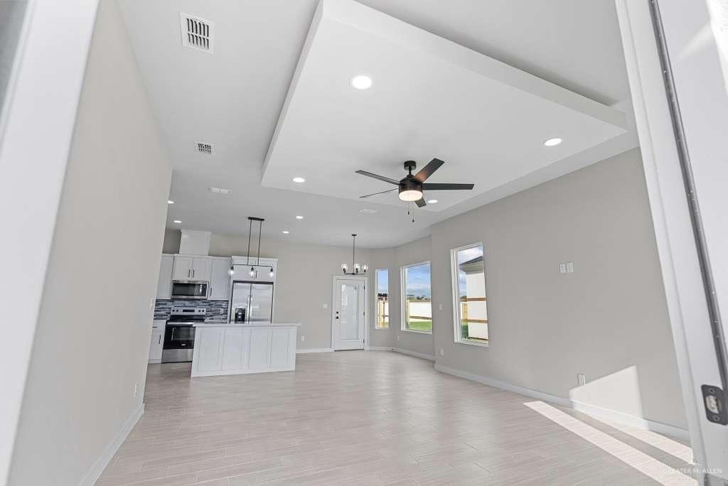 3501 Kerps Street Weslaco, TX 78599 - Photo 5 of 12 a view of a kitchen with a sink and dishwasher a refrigerator with wooden floor
