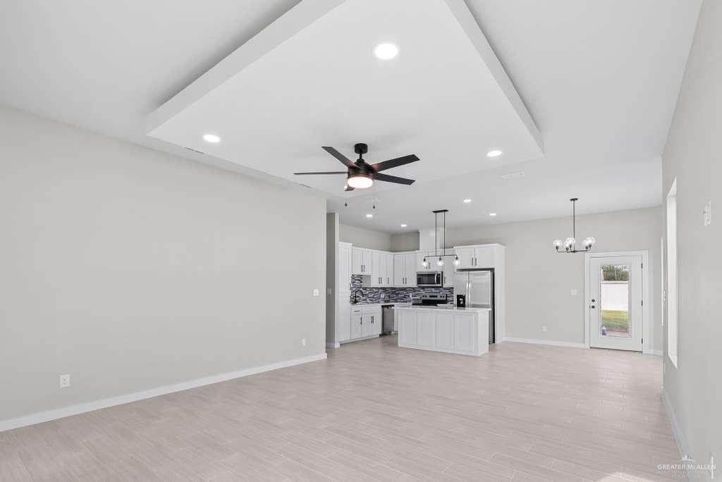 3501 Kerps Street Weslaco, TX 78599 - Photo 7 of 12 a view of a kitchen with a sink and a refrigerator