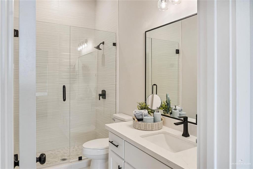3501 Kerps Street Weslaco, TX 78599 - Photo 9 of 12 a bathroom with a sink toilet and shower