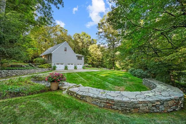 a view of a house with a yard and potted plants