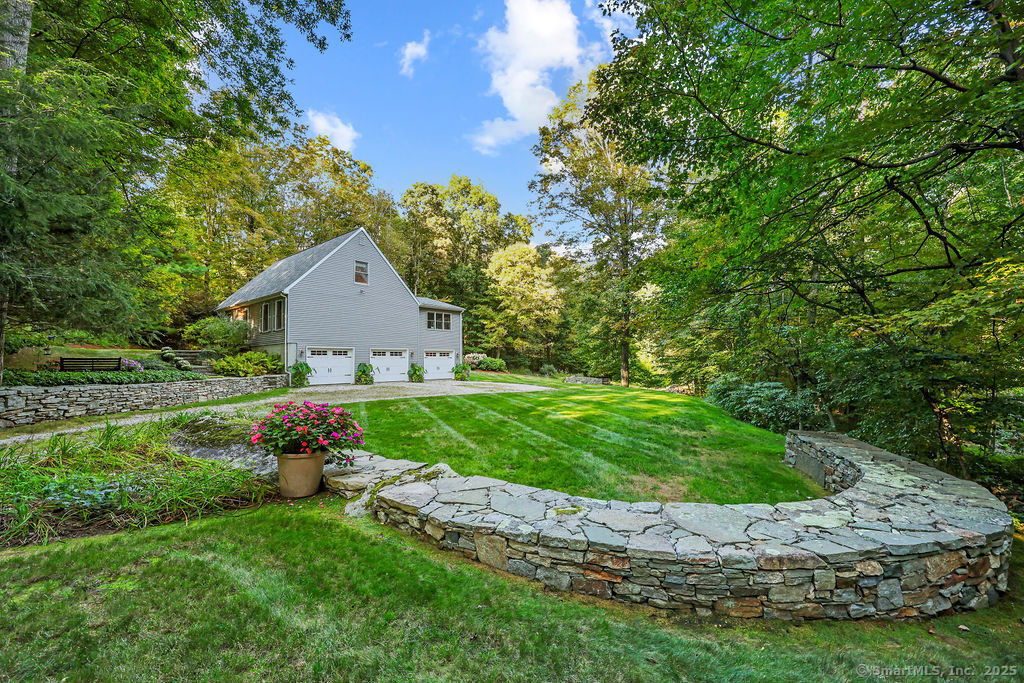 a view of a house with a yard and potted plants