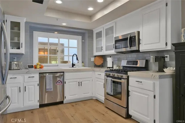 a kitchen with a refrigerator and a sink