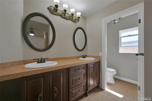 a bathroom with a sink toilet a mirror and shower