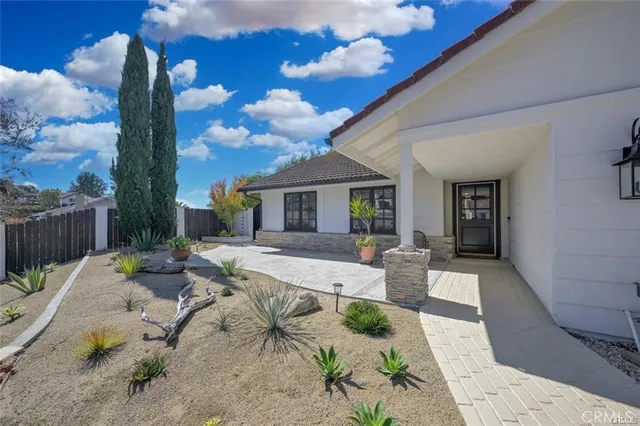 a view of a patio with couches table and chairs and potted plants