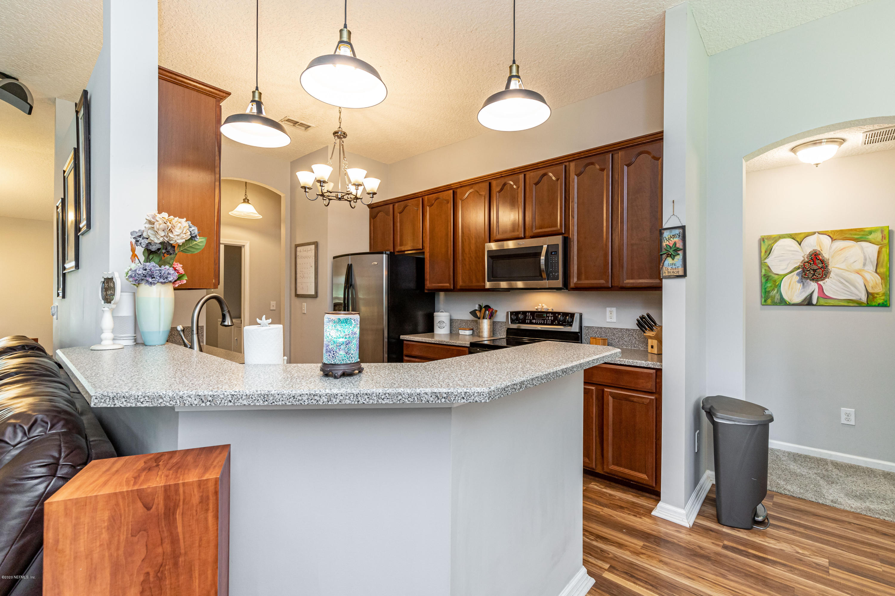 951 Silver Spring Court St. Augustine, FL 32092 - Photo 17 of 40 a kitchen with stainless steel appliances granite countertop a sink refrigerator and microwave