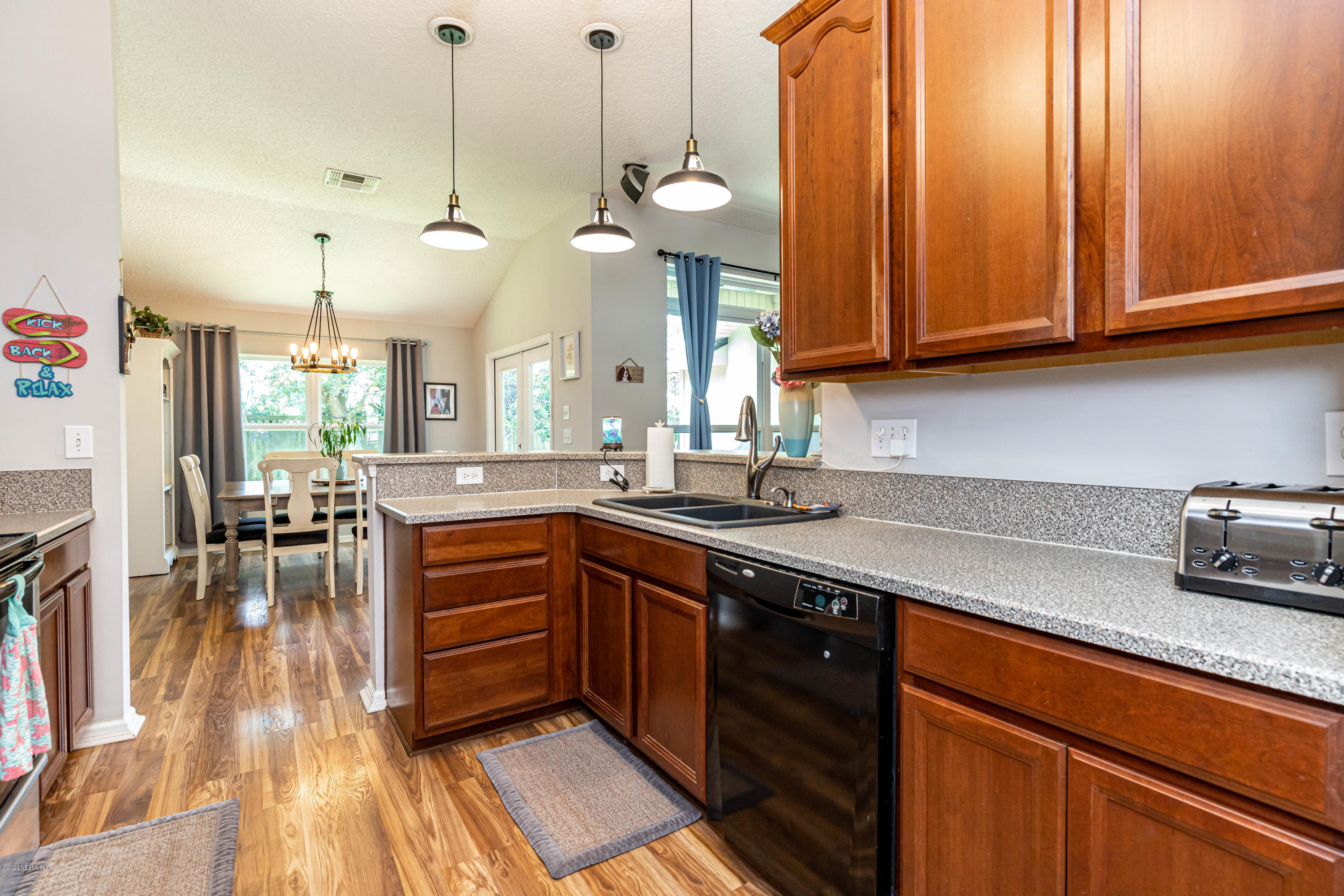 951 Silver Spring Court St. Augustine, FL 32092 - Photo 19 of 40 a kitchen with stainless steel appliances granite countertop a sink a stove and a wooden floors