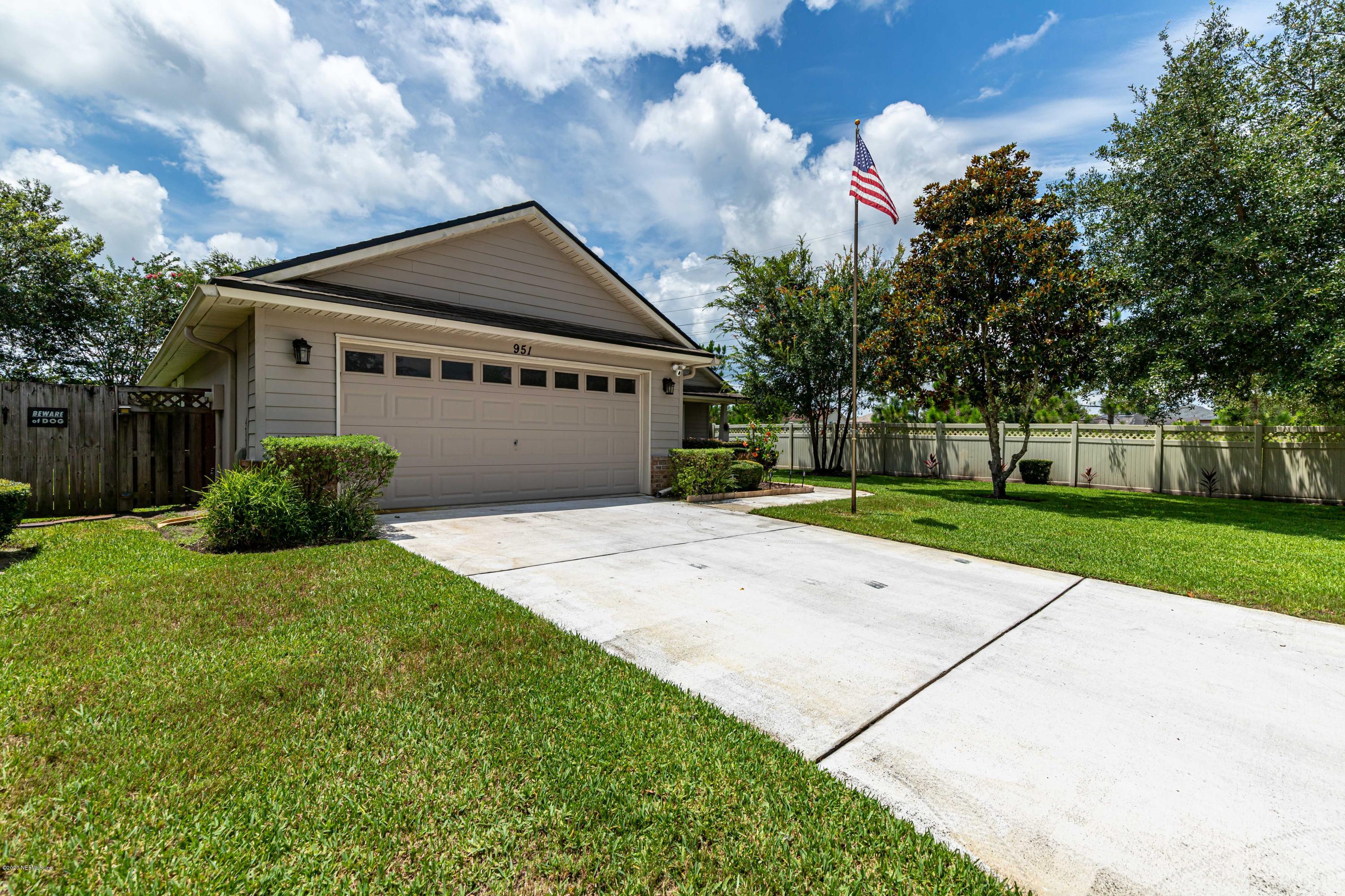 951 Silver Spring Court St. Augustine, FL 32092 - Photo 2 of 40 a front view of a house with a yard and garage