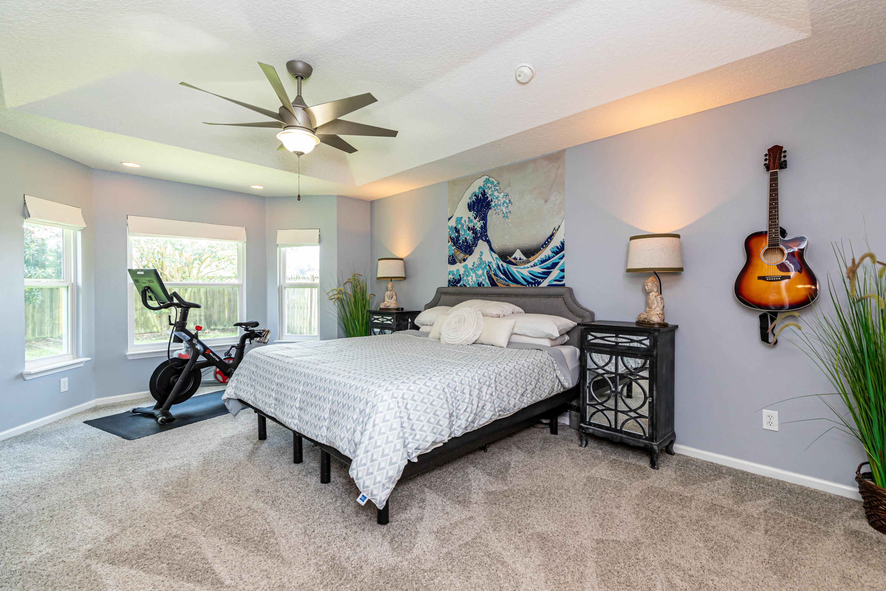 951 Silver Spring Court St. Augustine, FL 32092 - Photo 22 of 40 a bedroom with a bed and a chandelier