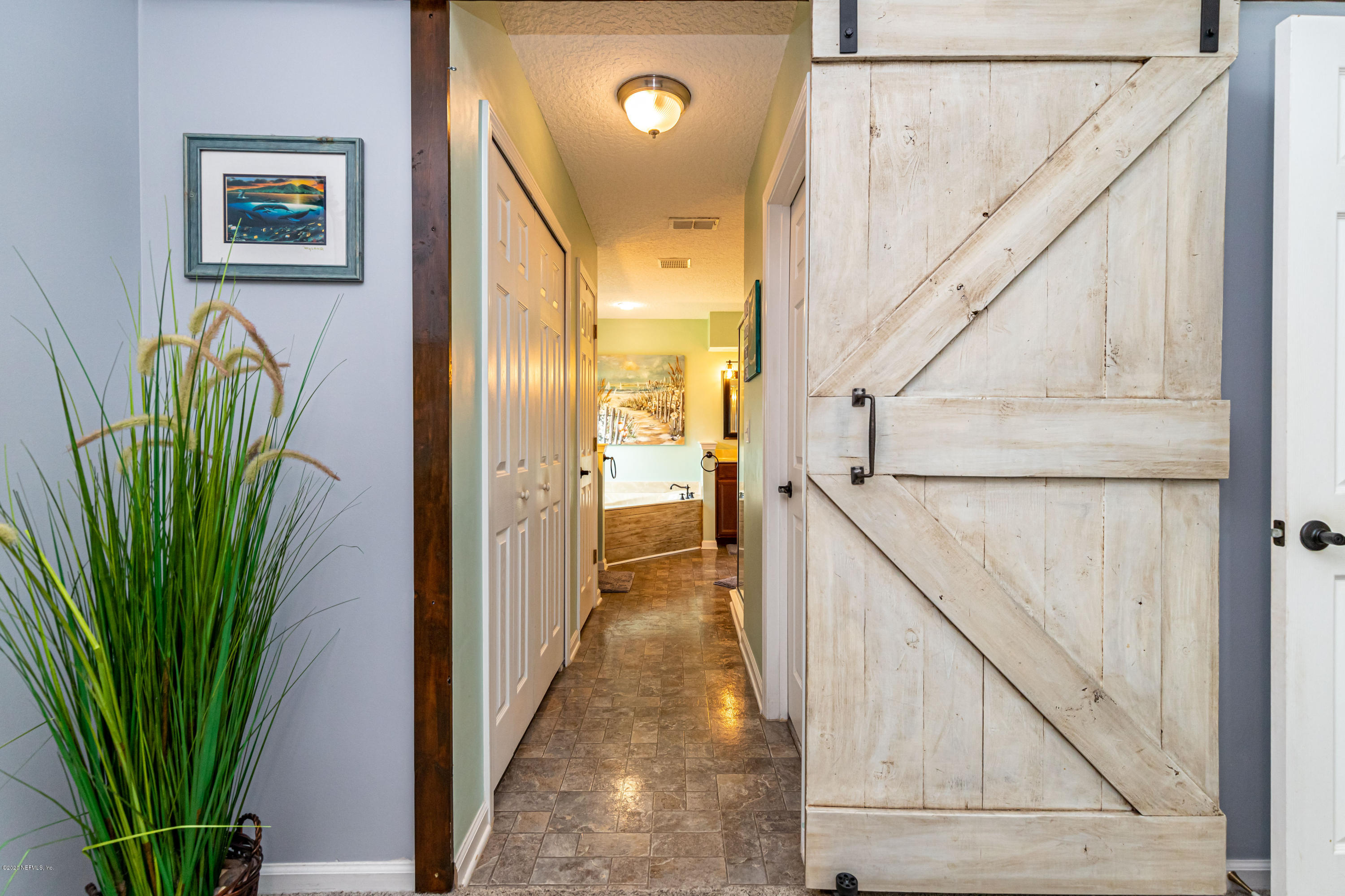 951 Silver Spring Court St. Augustine, FL 32092 - Photo 25 of 40 a view of a hallway with wooden floor and stairs