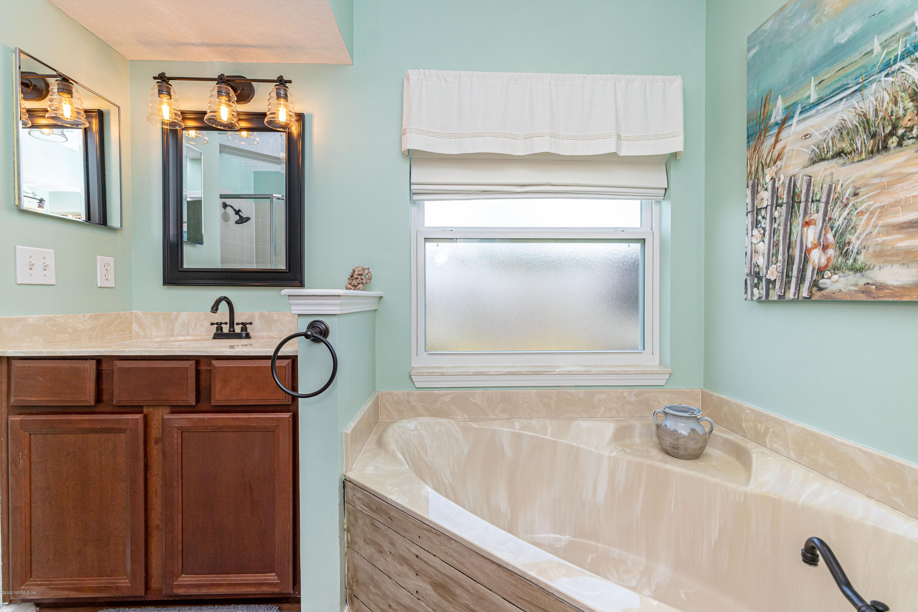951 Silver Spring Court St. Augustine, FL 32092 - Photo 27 of 40 a bathroom with a bathtub sink and mirror