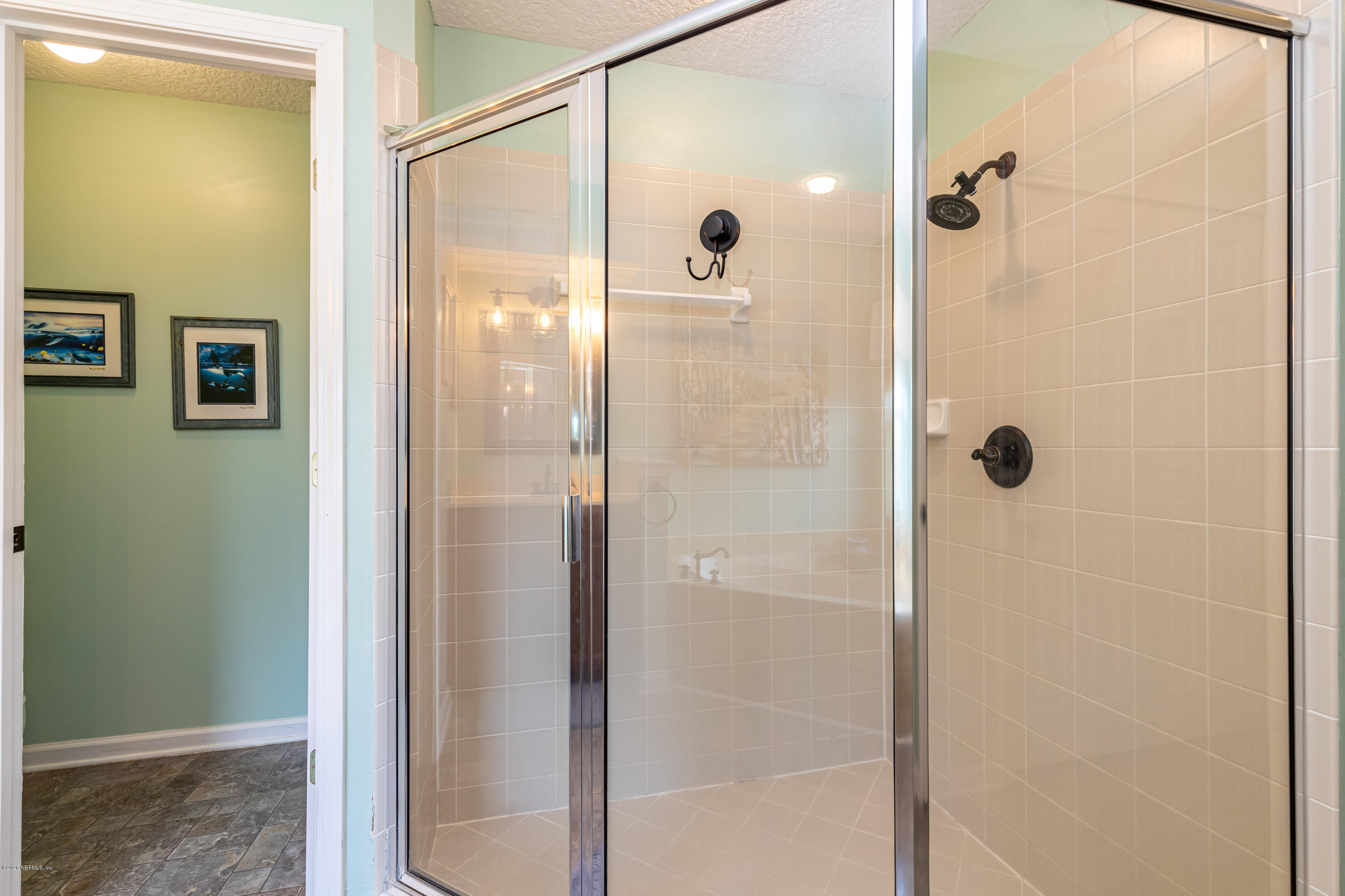 951 Silver Spring Court St. Augustine, FL 32092 - Photo 29 of 40 a bathroom with a glass shower door