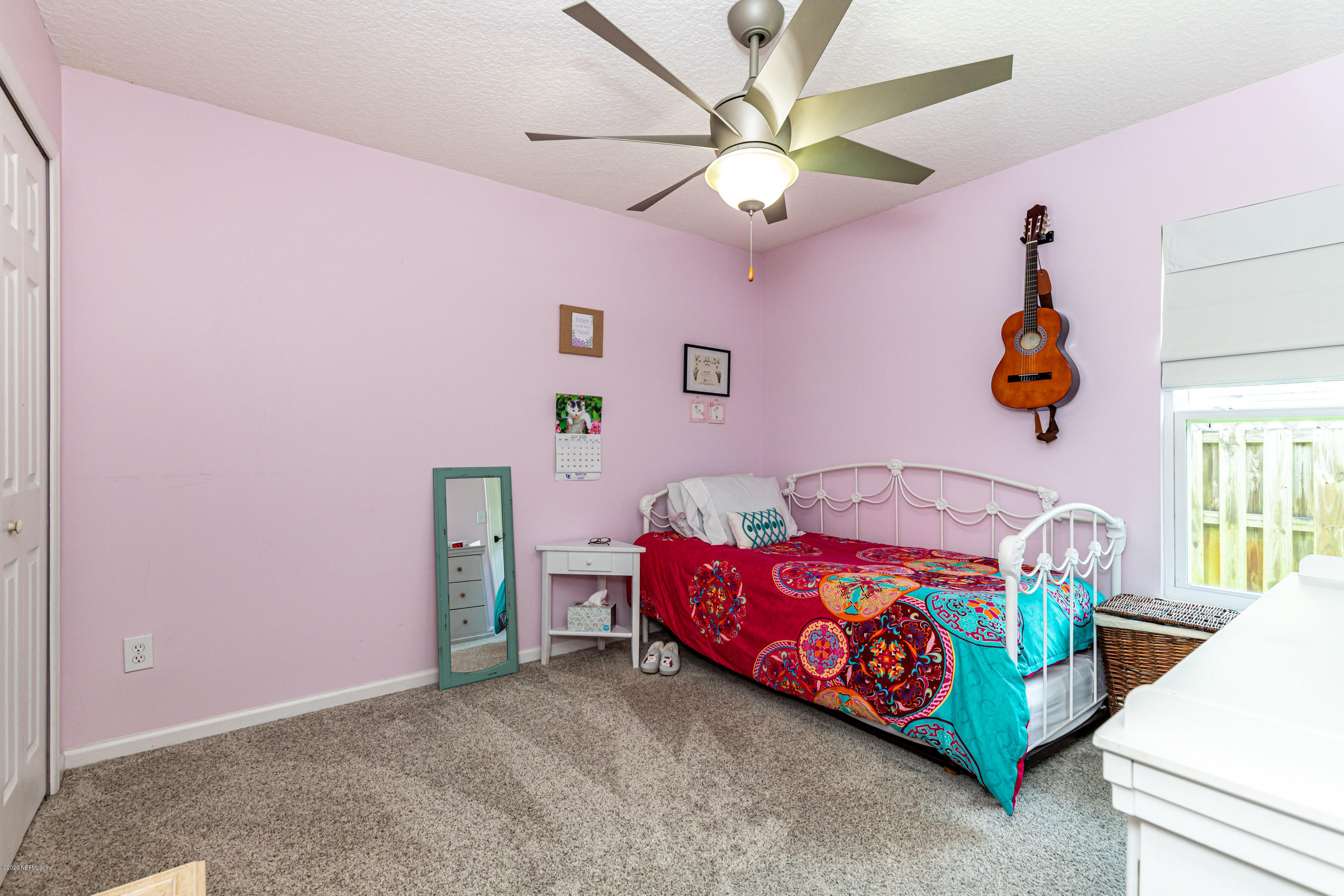951 Silver Spring Court St. Augustine, FL 32092 - Photo 31 of 40 a bedroom with a bed and a chandelier
