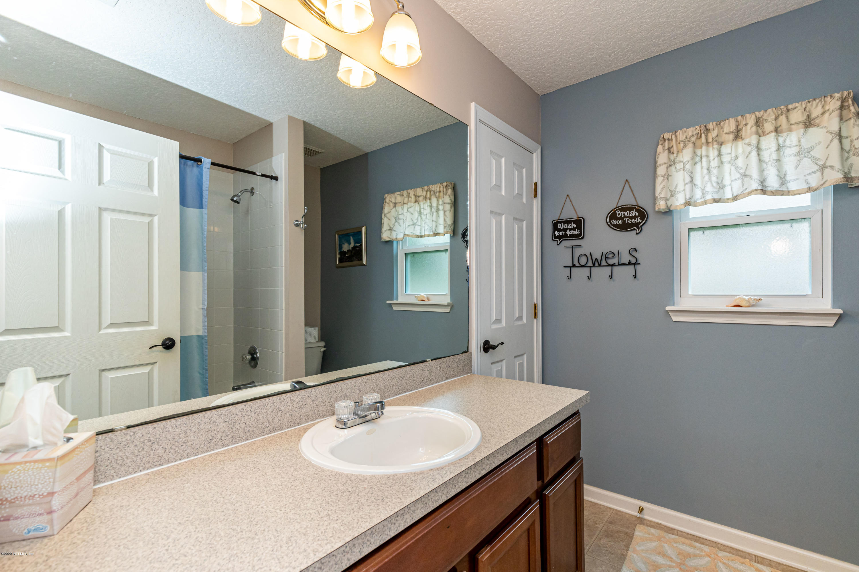 951 Silver Spring Court St. Augustine, FL 32092 - Photo 33 of 40 a bathroom with a sink and a mirror