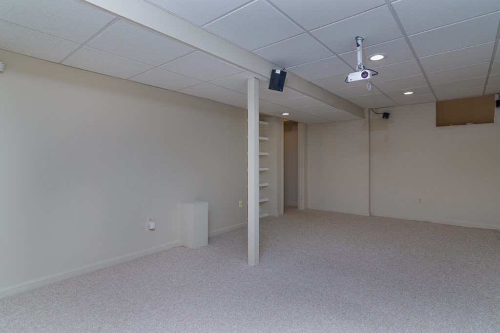 38 Farmland Road, Unit A Lowell, MA 01850 - Photo 23 of 26 an empty room with stairs and a chandelier fan