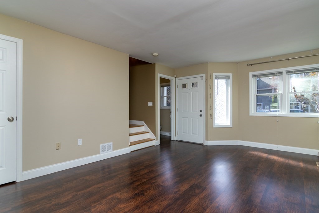 38 Farmland Road, Unit A Lowell, MA 01850 - Photo 4 of 26 a view of an empty room with wooden floor and windows