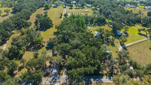 an aerial view of residential houses with outdoor space and swimming pool